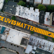 In this June 15, 2020, file photo, a giant “BLACK LIVES MATTER” sign is painted in orange on Fulton Street, Monday, June 15, 2020, in the Brooklyn borough of New York. Black Lives Matter Global Network Foundation, the group behind the emergence of the Black Lives Matter movement, has established a more than $12 million fund to aid organizations fighting institutional racism in the wake of the George Floyd protests.